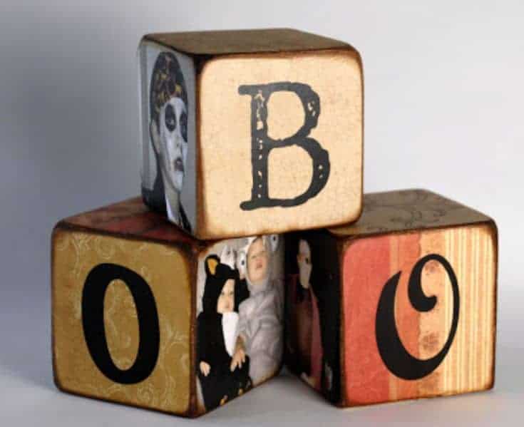 wooden blocks  with images and letters forming a word boo