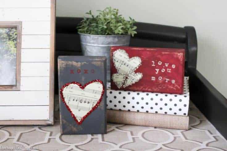 two wooden blocks with valentines decoration next to a photo frame