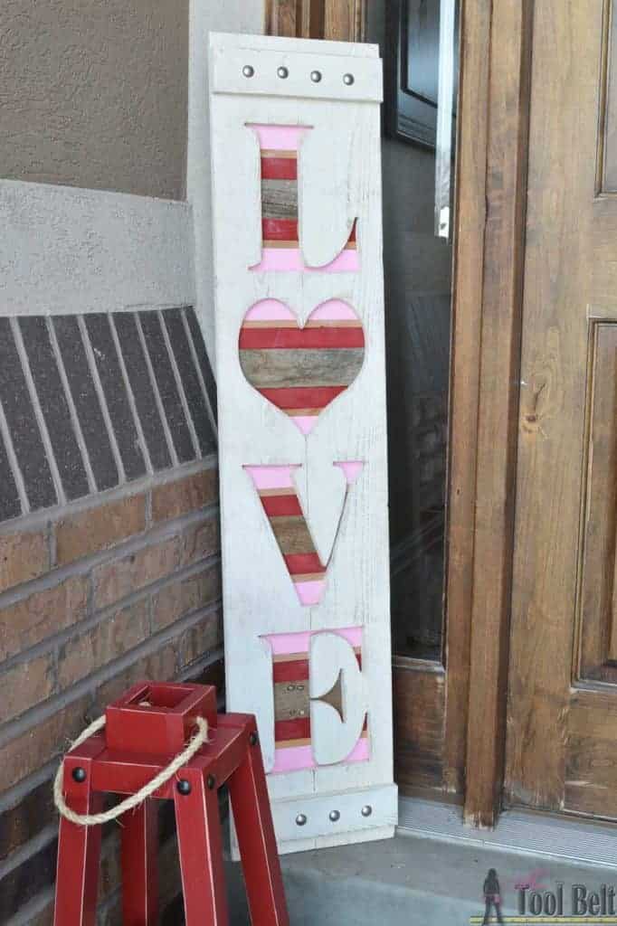 a wood sing with love word carved on the porch