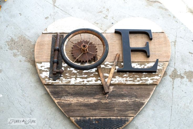 wooden sign in a heart shape with love word made out of scraps