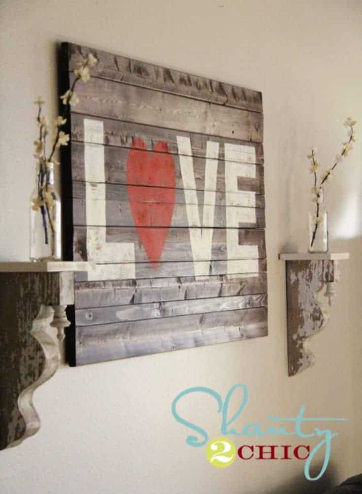 wooden sign with a word love hanged on the wall