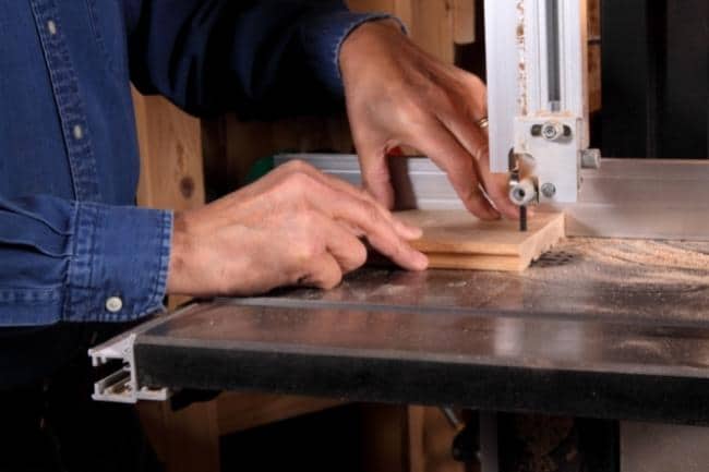 How To Use A Bandsaw Safely-man cutting wood with a bandsaw