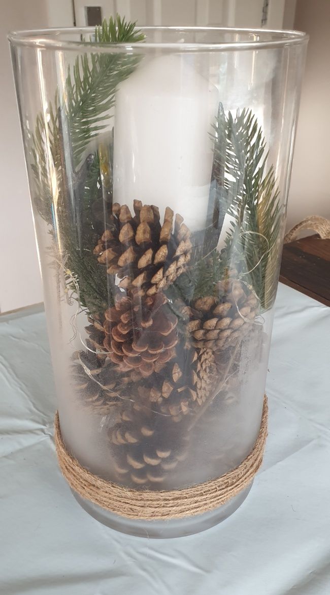DIY winter decor candle display/centerpiece with pinecones and led fairy lights in a hurricane glass vase