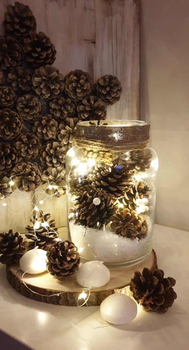 diy rustic winter pinecone vase home decor with light up led fairy lights on a wooden slice