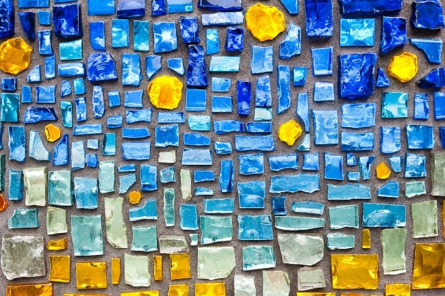colorful-yellow and blue-glass tile pieces placed on the floor